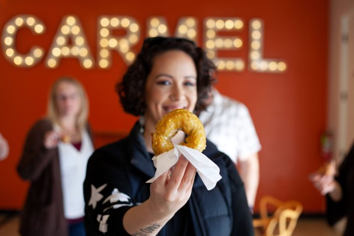 a person eating a bougie donut