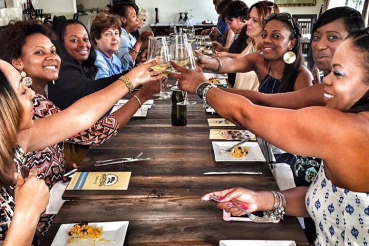 a group of people sitting at a table with wine glasses